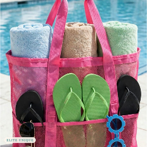 Large Mesh Beach Tote in hot pink by a pool, packed with towels, flip-flops and sunglasses